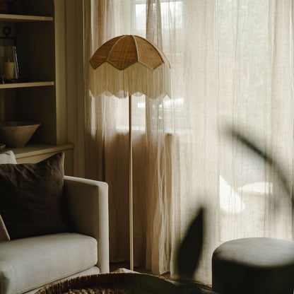 Futuristic umbrella-like structure in a room with a couch and shelves.